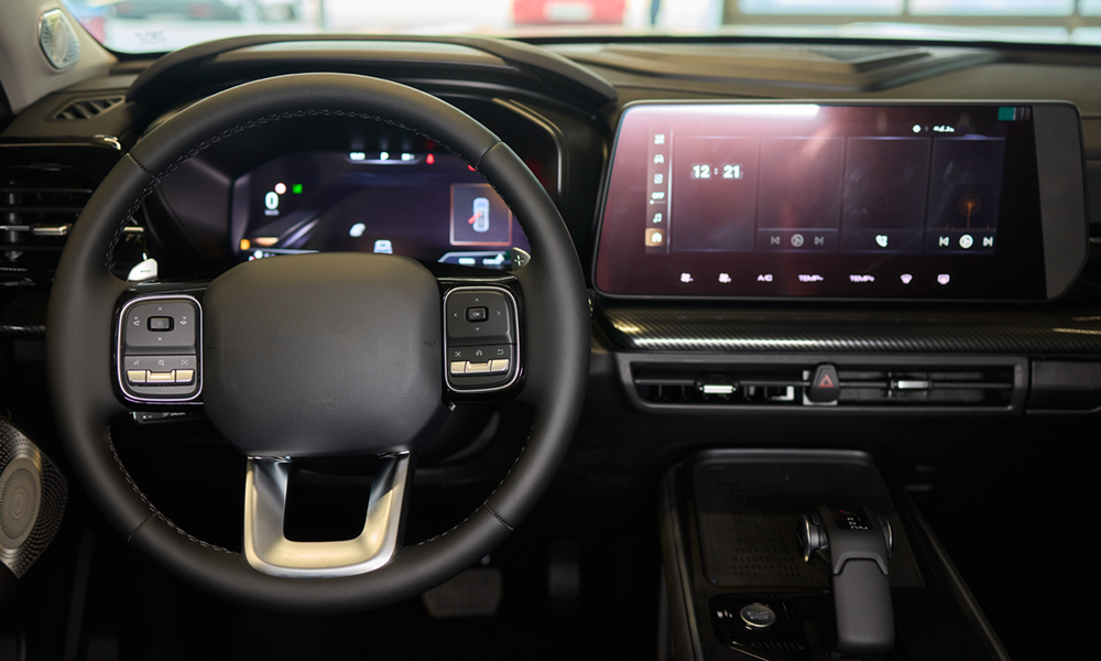 Closeup of a modern car steering wheel with control buttons for technology and convenience