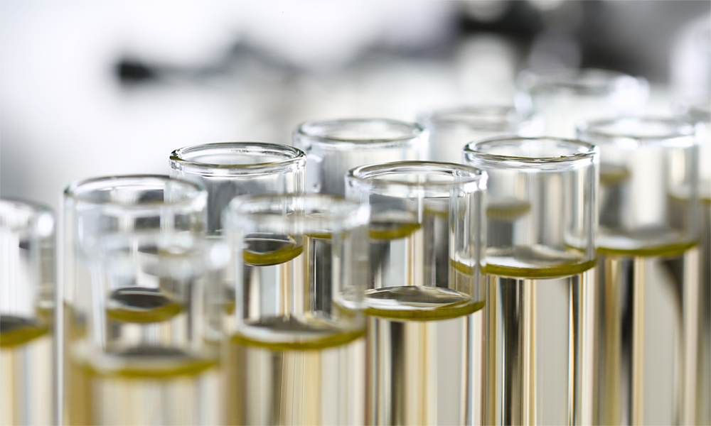 Close-up of transparent glass test tubes with liquid, representing Momentive’s innovative chemical solutions for customized product formulations and enhanced manufacturing efficiency.