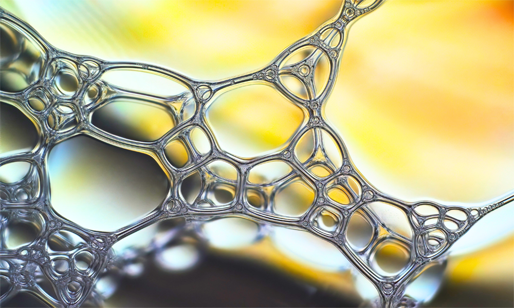 Close-up of foam bubbles under bright light, illustrating Momentive’s SAG™ antifoam technology for superior foam control in industrial processes.