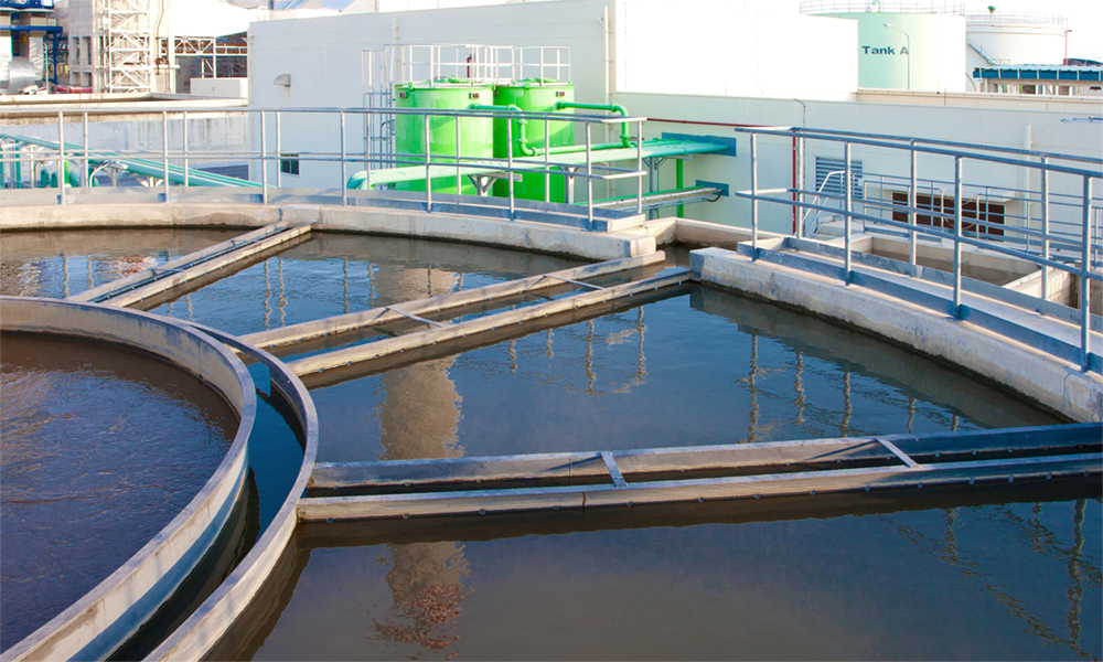 Industrial water treatment facility with circular tanks, representing Momentive’s commitment to regulatory compliance and sustainable operations guidance.