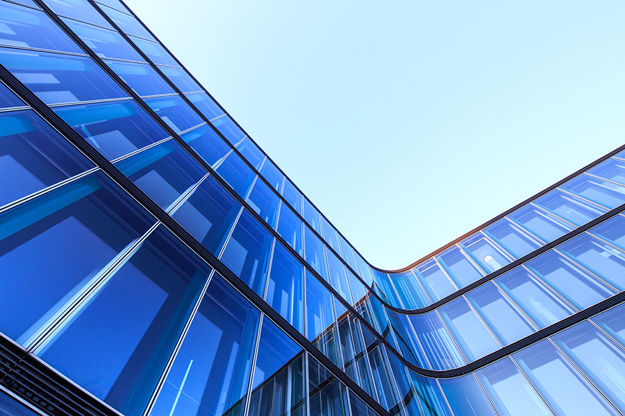 L-shaped glass facade of a modern office building in Hamburg, Germany.