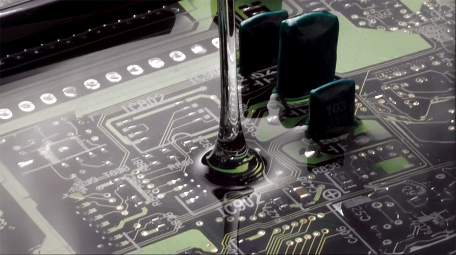 Gel being poured on circuit board