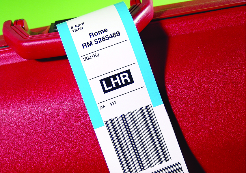 Red suitcase with generic luggage label (not actual label - generated new artwork based on a label)