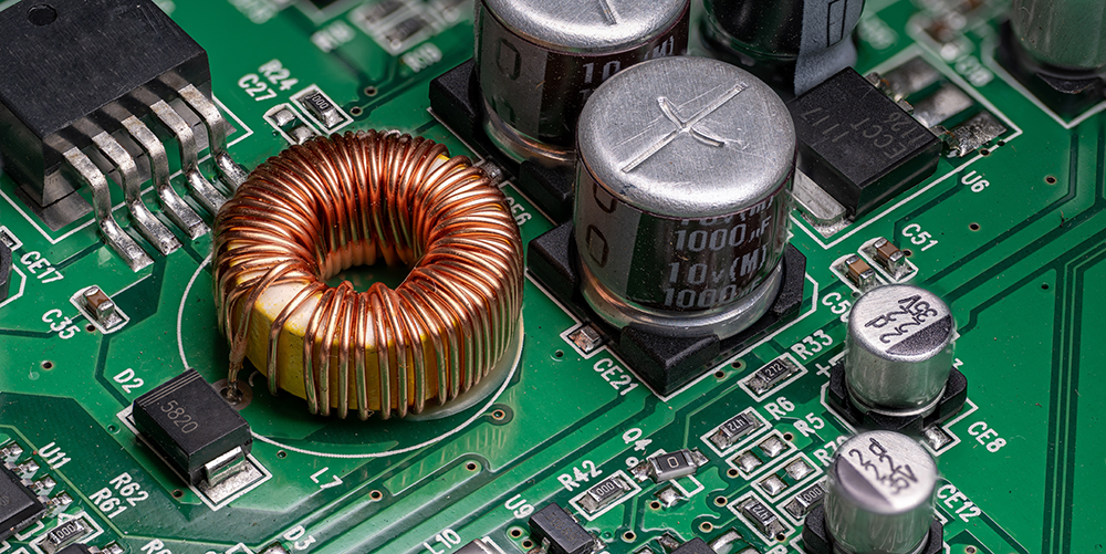 Circular coil with copper wire on printed circuit board.